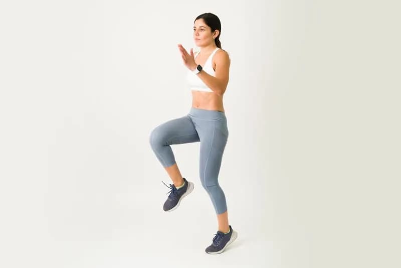 woman-working-out-indoors-with-high-knees-exercise-2026-03-26-23-46-55-utc.jpg