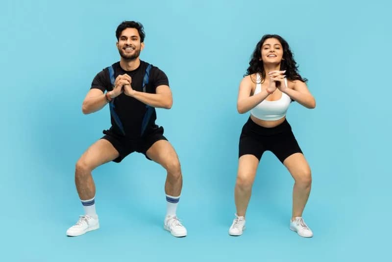 young-man-and-woman-exercising-with-squats-2026-01-08-07-44-01-utc.jpg