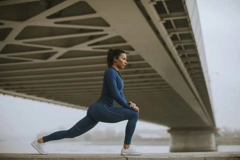 young-woman-in-blue-track-suit-stretching-before-w-2026-03-19-05-29-14-utc.jpg