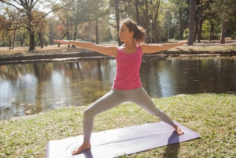 young woman performing yoga exercise in warrior po 2026 03 26 06 04 40 utc 3